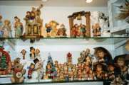a lot of hummel figurines in the showcase